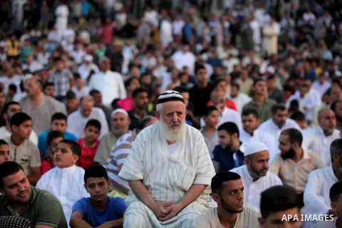 Palestinians attend the morning prayers for Eid al-Fitr celebrations, which marks the end of the holy fasting month of Ramadan, in Gaza City July 6, 2016. Photo by Ashraf Amra