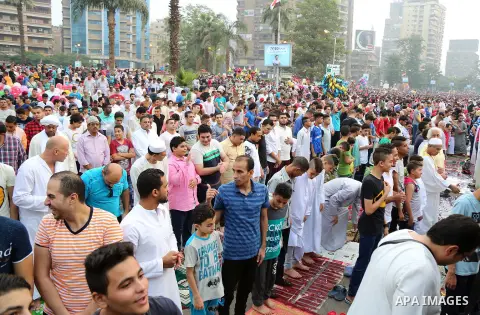 Egyptian Muslims attend the morning prayers for Eid al-Fitr celebrations, which marks the end of the holy fasting month of Ramadan, at Mustafa Mahmoud Squar, in Cairo, Egypt, on July 06, 2016. Photo by Amr Sayed