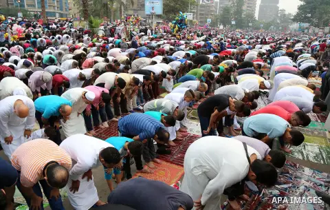 Egyptian Muslims attend the morning prayers for Eid al-Fitr celebrations, which marks the end of the holy fasting month of Ramadan, at Mustafa Mahmoud Squar, in Cairo, Egypt, on July 06, 2016. Photo by Amr Sayed