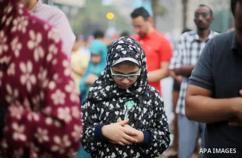 Egyptian Muslims attend the morning prayers for Eid al-Fitr celebrations, which marks the end of the holy fasting month of Ramadan, at Mustafa Mahmoud Squar, in Cairo, Egypt, on July 06, 2016. Photo by Amr Sayed