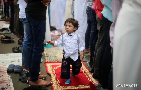 Egyptian Muslims attend the morning prayers for Eid al-Fitr celebrations, which marks the end of the holy fasting month of Ramadan, at Mustafa Mahmoud Squar, in Cairo, Egypt, on July 06, 2016. Photo by Amr Sayed