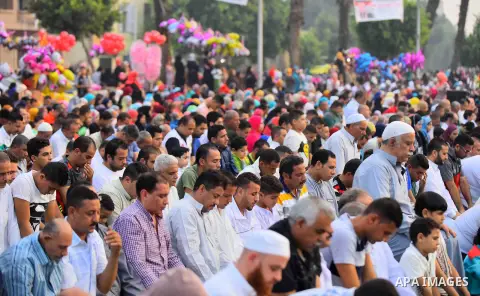 Egyptian Muslims attend the morning prayers for Eid al-Fitr celebrations, which marks the end of the holy fasting month of Ramadan, outside Amr Ibn El-Aas mosque, in Cairo, Egypt, on July 06, 2016. Photo by Amr Sayed