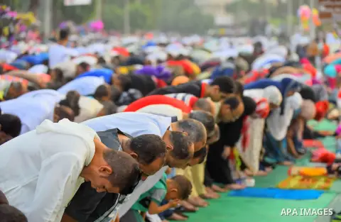 Egyptian Muslims attend the morning prayers for Eid al-Fitr celebrations, which marks the end of the holy fasting month of Ramadan, outside Amr Ibn El-Aas mosque, in Cairo, Egypt, on July 06, 2016. Photo by Amr Sayed