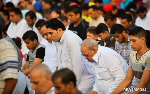 Egyptian Muslims attend the morning prayers for Eid al-Fitr celebrations, which marks the end of the holy fasting month of Ramadan, outside Amr Ibn El-Aas mosque, in Cairo, Egypt, on July 06, 2016. Photo by Amr Sayed