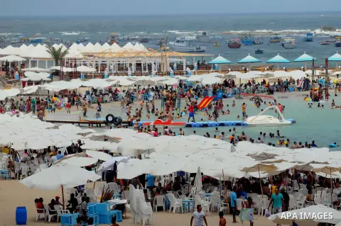 Egyptians crowd a slide at a public beach on the first day of Eid al-Fitr celebrations, which marks the end of the holy fasting month of Ramadan, in the Mediterranean city of Alexandria, in the north of Cairo July 6, 201...