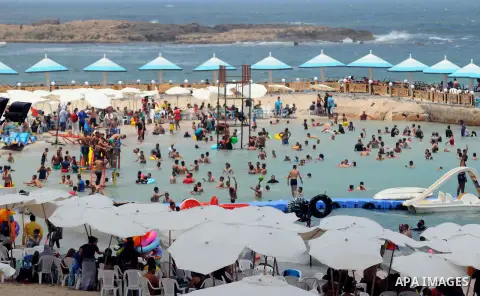Egyptians crowd a slide at a public beach on the first day of Eid al-Fitr celebrations, which marks the end of the holy fasting month of Ramadan, in the Mediterranean city of Alexandria, in the north of Cairo July 6, 201...