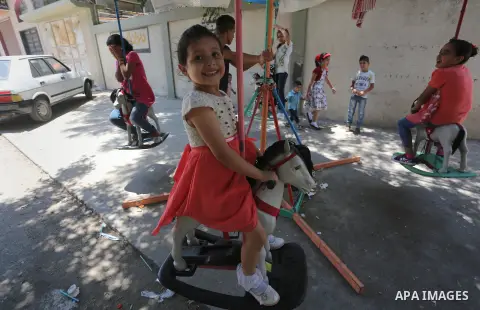 Palestinian children play on the second day of of Eid al-Fitr celebrations, which marks the end of the holy fasting month of Ramadan, at the al-Shati refugee camp in Gaza City on July 7, 2016. Photo by Mohammed Asad