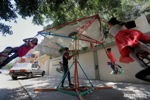 Palestinian children play on the second day of of Eid al-Fitr celebrations, which marks the end of the holy fasting month of Ramadan, at the al-Shati refugee camp in Gaza City on July 7, 2016. Photo by Mohammed Asad