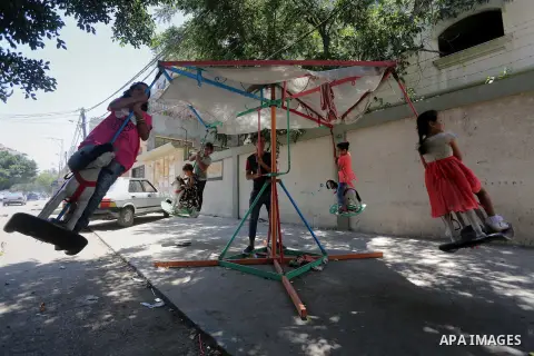 Palestinian children play on the second day of of Eid al-Fitr celebrations, which marks the end of the holy fasting month of Ramadan, at the al-Shati refugee camp in Gaza City on July 7, 2016. Photo by Mohammed Asad