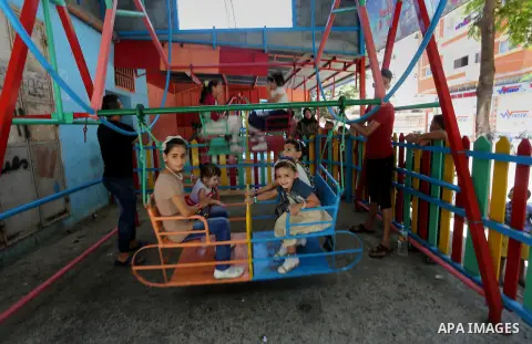 Palestinian children play on the second day of of Eid al-Fitr celebrations, which marks the end of the holy fasting month of Ramadan, at the al-Shati refugee camp in Gaza City on July 7, 2016. Photo by Mohammed Asad