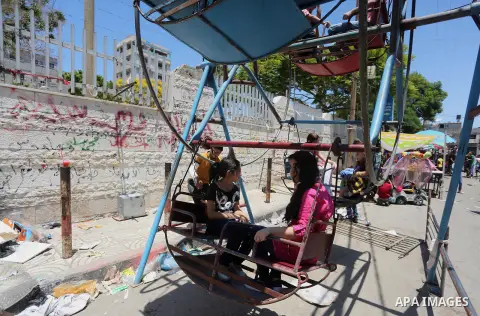 Palestinian children play on the second day of of Eid al-Fitr celebrations, which marks the end of the holy fasting month of Ramadan, at the al-Shati refugee camp in Gaza City on July 7, 2016. Photo by Mohammed Asad