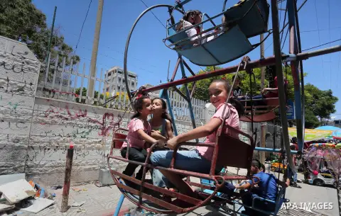 Palestinian children play on the second day of of Eid al-Fitr celebrations, which marks the end of the holy fasting month of Ramadan, at the al-Shati refugee camp in Gaza City on July 7, 2016. Photo by Mohammed Asad