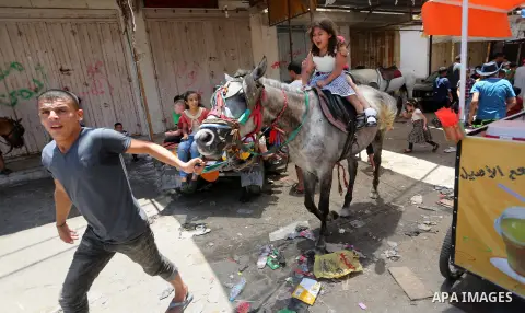 Palestinian children play on the second day of of Eid al-Fitr celebrations, which marks the end of the holy fasting month of Ramadan, at the al-Shati refugee camp in Gaza City on July 7, 2016. Photo by Mohammed Asad