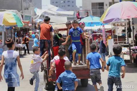 Palestinian children play on the second day of of Eid al-Fitr celebrations, which marks the end of the holy fasting month of Ramadan, at the al-Shati refugee camp in Gaza City on July 7, 2016. Photo by Mohammed Asad