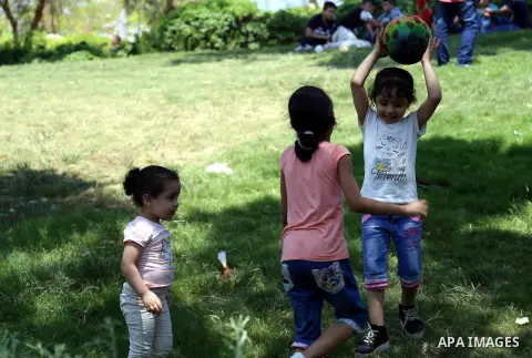Egyptians play at a garden on the second day of of Eid al-Fitr celebrations, which marks the end of the holy fasting month of Ramadan, in Cairo, Egypt, on July 7, 2016. Photo by Amr Sayed