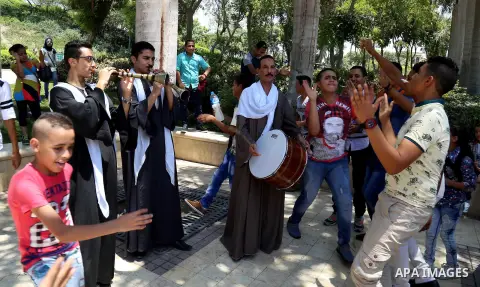 Egyptians play at a garden on the second day of of Eid al-Fitr celebrations, which marks the end of the holy fasting month of Ramadan, in Cairo, Egypt, on July 7, 2016. Photo by Amr Sayed