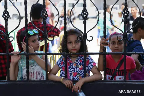 Egyptians play at a garden on the second day of of Eid al-Fitr celebrations, which marks the end of the holy fasting month of Ramadan, in Cairo, Egypt, on July 7, 2016. Photo by Amr Sayed
