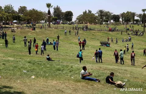 Egyptians play at a garden on the second day of of Eid al-Fitr celebrations, which marks the end of the holy fasting month of Ramadan, in Cairo, Egypt, on July 7, 2016. Photo by Amr Sayed