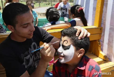 Egyptians play at a garden on the second day of of Eid al-Fitr celebrations, which marks the end of the holy fasting month of Ramadan, in Cairo, Egypt, on July 7, 2016. Photo by Amr Sayed