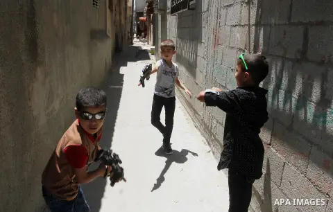 Palestinian boys play with toy guns to celebrate Eid al-Fitr during the second day of the holiday of Eid al-Fitr marking the end of Islam's fasting holy month of Ramadan, in Rafah in the southern Gaza strip, on July 7, 2...
