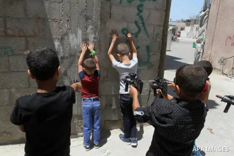 Palestinian boys play with toy guns to celebrate Eid al-Fitr during the second day of the holiday of Eid al-Fitr marking the end of Islam's fasting holy month of Ramadan, in Rafah in the southern Gaza strip, on July 7, 2...