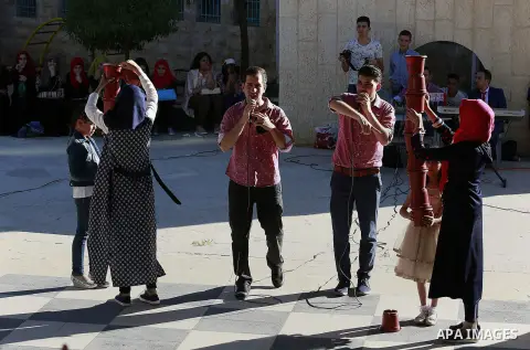 Palestinian children play to celebrate Eid al-Fitr during the second day of the holiday of Eid al-Fitr marking the end of Islam's fasting holy month of Ramadan, in the West Bank city of Hebron, on July 7, 2016. Photo by...