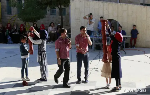 Palestinian children play to celebrate Eid al-Fitr during the second day of the holiday of Eid al-Fitr marking the end of Islam's fasting holy month of Ramadan, in the West Bank city of Hebron, on July 7, 2016. Photo by...