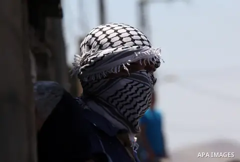 A Palestinian protester looks on during clashes with Israeli security forces following a demonstration against the expropriation of Palestinian land by Israel on July 08, 2016 in the village of Kfar Qaddum, near Nablus,...