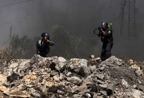 Israeli security forces aim their weapons at Palestinian protesters during clashes following a demonstration against the expropriation of Palestinian land by Israel on July 08, 2016 in the village of Kfar Qaddum, near Na...