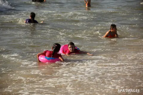 Palestinian children swim in the Mediterranean sea on the coast of Gaza city, on the third day of Eid al-Fitr holiday which marks the end of the Muslim holy month of Ramadan, on July 08, 2016. Photo by Ashraf Amra