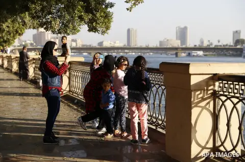 Egyptians walk past Nile River on the third day of Eid al-Fitr holiday which marks the end of the Muslim holy month of Ramadan, in Cairo, Egypt, on July 08, 2016. Photo by Amr Sayed