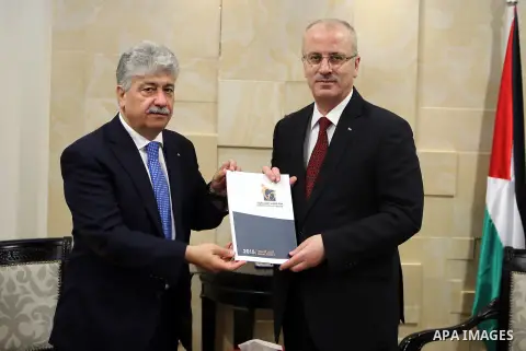 Palestinian Prime Minister, Rami Hamdallah, receives the Annual report of the Retirement Authority for 2015 in the West Bank city of Ramallah on July 11 , 2016. Photo by Prime Minister Office