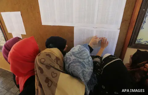 Palestinian high school students look for their results of final high school exams, known as "Tawjihi" in Gaza city on July 11, 2016. Photo by Mohammed Asad