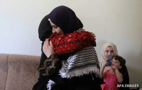 A Palestinian high school student, Sabrin Sheikh Ahmed 99.4, celebrates with her family after heard the results of her final exams known as ''Tawjihi'', in Khan Younis in the southern Gaza strip, on July 11, 2016. Photo...