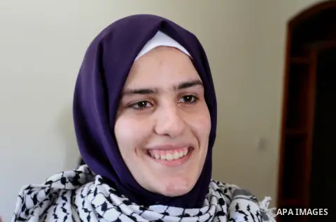 A Palestinian high school student, Sabrin Sheikh Ahmed 99.4, celebrates with her family after heard the results of her final exams known as ''Tawjihi'', in Khan Younis in the southern Gaza strip, on July 11, 2016. Photo...