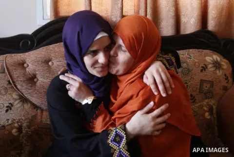 A Palestinian high school student, Sabrin Sheikh Ahmed 99.4, celebrates with her family after heard the results of her final exams known as ''Tawjihi'', in Khan Younis in the southern Gaza strip, on July 11, 2016. Photo...