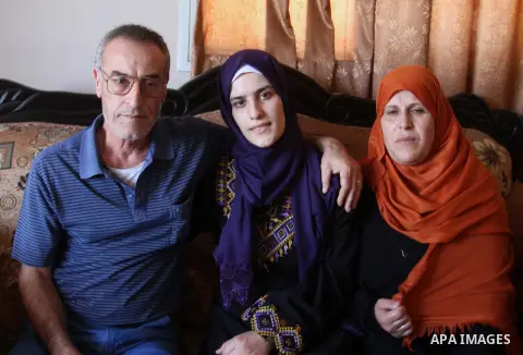 A Palestinian high school student, Sabrin Sheikh Ahmed 99.4, celebrates with her family after heard the results of her final exams known as ''Tawjihi'', in Khan Younis in the southern Gaza strip, on July 11, 2016. Photo...