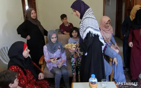 A Palestinian high school student, Sabrin Sheikh Ahmed 99.4, celebrates with her family after heard the results of her final exams known as ''Tawjihi'', in Khan Younis in the southern Gaza strip, on July 11, 2016. Photo...
