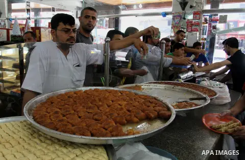 Palestinian vendors sell sweets after the results of high school exams, known as ''Tawjihi''', in Rafah in the southern Gaza strip, on July 11, 2016. Photo by Abed Rahim Khatib