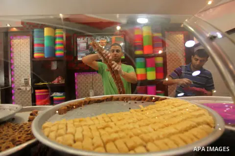 Palestinian vendors sell sweets after the results of high school exams, known as ''Tawjihi''', in Gaza city, on July 11, 2016. Photo by Ashraf Amra