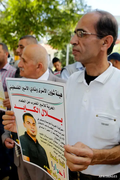 Palestinians take part in a demonstration calling for the release of Bilal Kayed a Palestinian prisoner on hunger strike, in the West bank city of Hebron on July 12, 2016. Photo by Wisam Hashlamoun