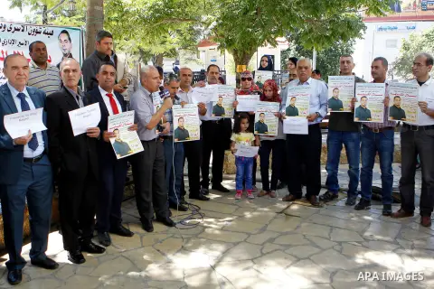 Palestinians take part in a demonstration calling for the release of Bilal Kayed a Palestinian prisoner on hunger strike, in the West bank city of Hebron on July 12, 2016. Photo by Wisam Hashlamoun