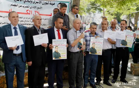 Palestinians take part in a demonstration calling for the release of Bilal Kayed a Palestinian prisoner on hunger strike, in the West bank city of Hebron on July 12, 2016. Photo by Wisam Hashlamoun