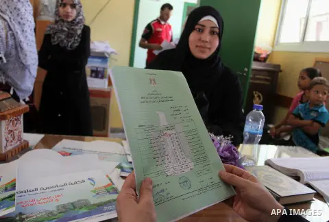 Palestinian high school students look for their results of final high school exams, known as "Tawjihi" in Rafah in the southern Gaza strip on July 12, 2016. Photo by Abed Rahim Khatib