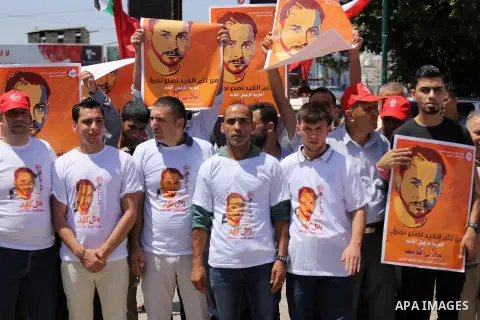 Supporters of the Popular Front for the Liberation of Palestine (PFLP) take part in a demonstration calling for the release of Bilal Kayed a Palestinian prisoner on hunger strike, in Gaza city on July 13, 2016. Photo by...
