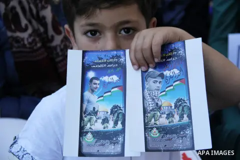 Relatives of Palestinian prisoners in Israeli jails take part in a protest against the decision of Israeli authorities minimize visits the Palestinian prisoners in front of Red cross office, in Jerusalem, on July 13, 201...