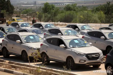 A Palestinian man inspects vehicles that came from Israel to serve the Gaza Strip market on July 14, 2016 in the Palestinian side of the Erez crossing with Israel. Israel opened the major Erez crossing point between Isra...
