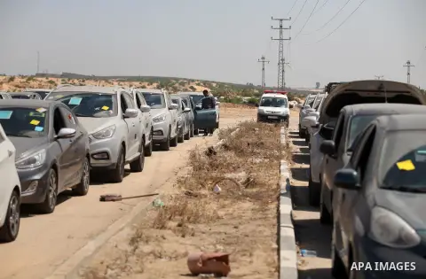 A Palestinian man inspects vehicles that came from Israel to serve the Gaza Strip market on July 14, 2016 in the Palestinian side of the Erez crossing with Israel. Israel opened the major Erez crossing point between Isra...