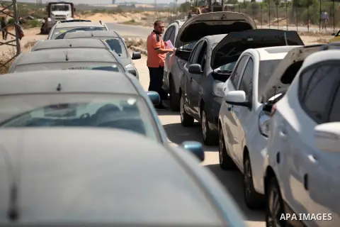 A Palestinian man inspects vehicles that came from Israel to serve the Gaza Strip market on July 14, 2016 in the Palestinian side of the Erez crossing with Israel. Israel opened the major Erez crossing point between Isra...