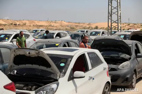 Palestinian men inspect vehicles that came from Israel to serve the Gaza Strip market on July 14, 2016 in the Palestinian side of the Erez crossing with Israel. Israel opened the major Erez crossing point between Israel...
